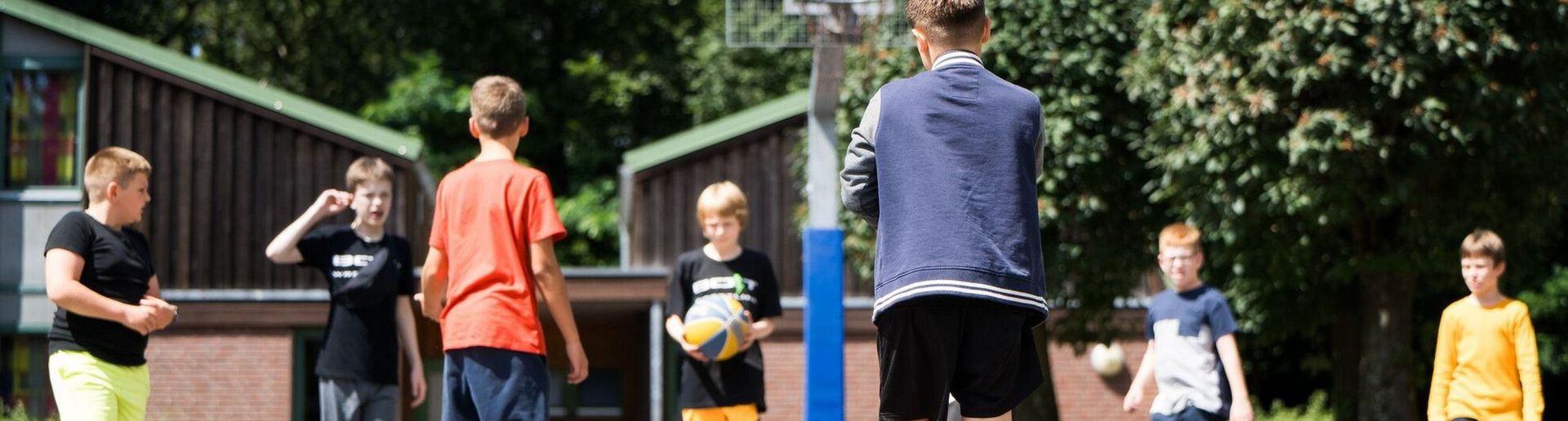 Kinder spielen Basketball
